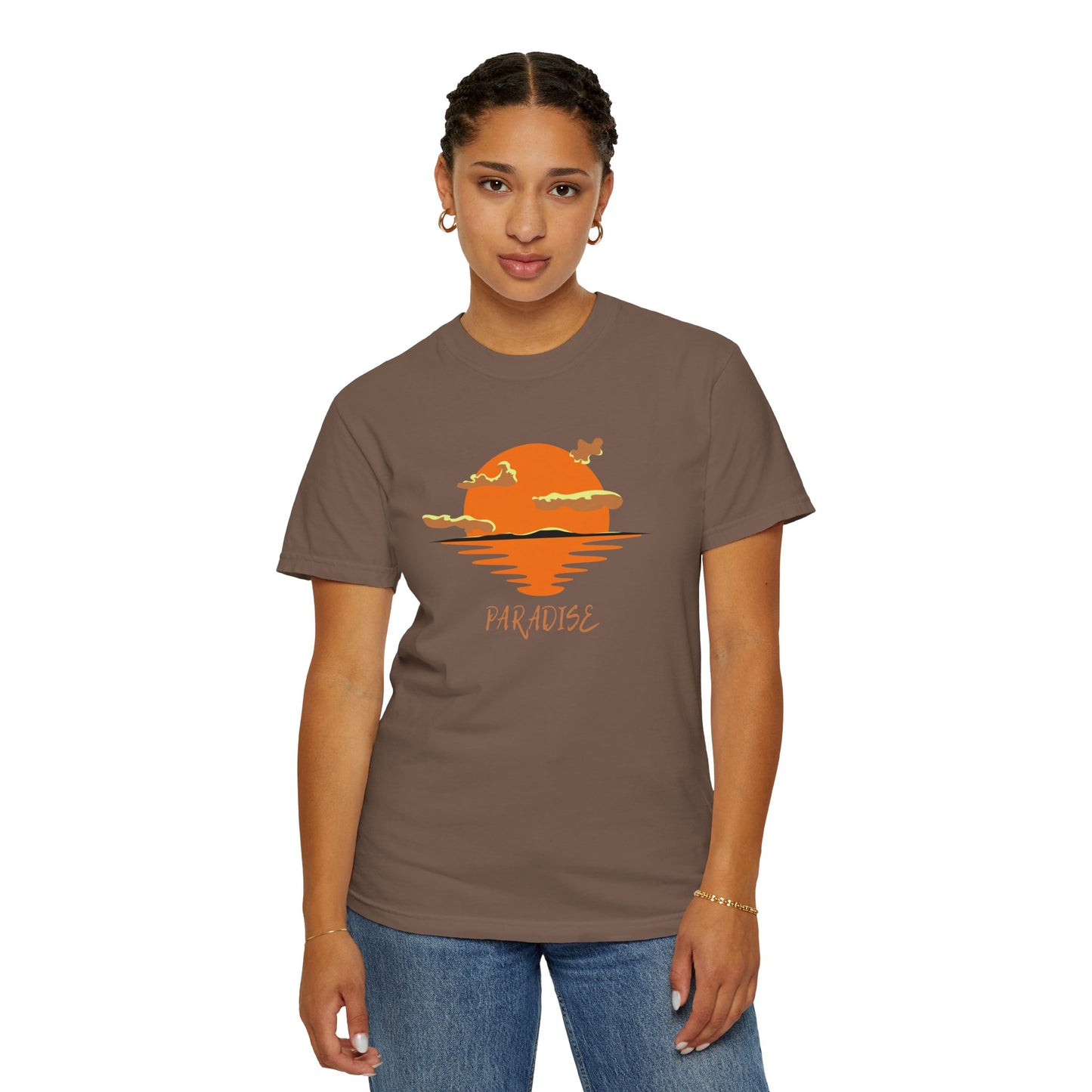 Woman wearing a brown t-shirt with a sunset and 'Paradise' design on a white background