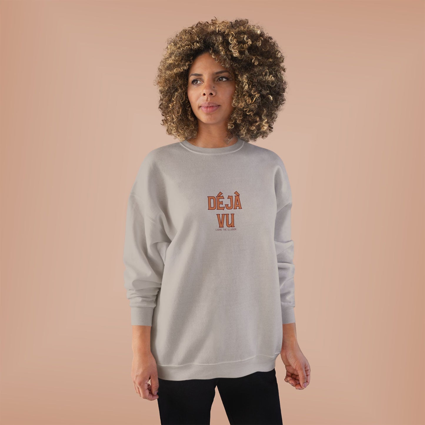 Person wearing a gray sweatshirt with 'DEJA VU' text on a beige background
