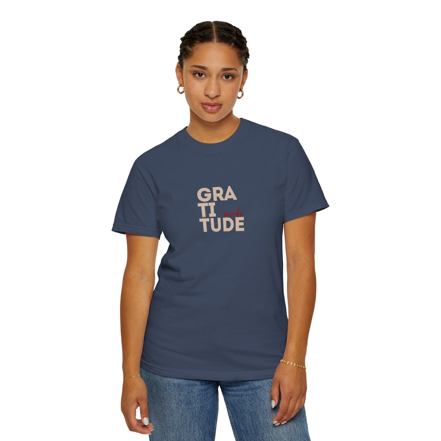 Person wearing a navy blue t-shirt with 'GRATITUDE' printed on it against a white background