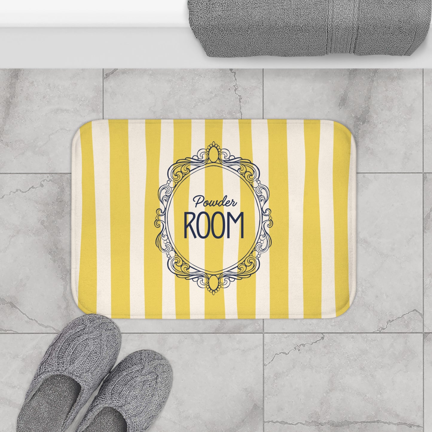 Yellow and white striped doormat with 'Powder Room' text on a tiled floor.