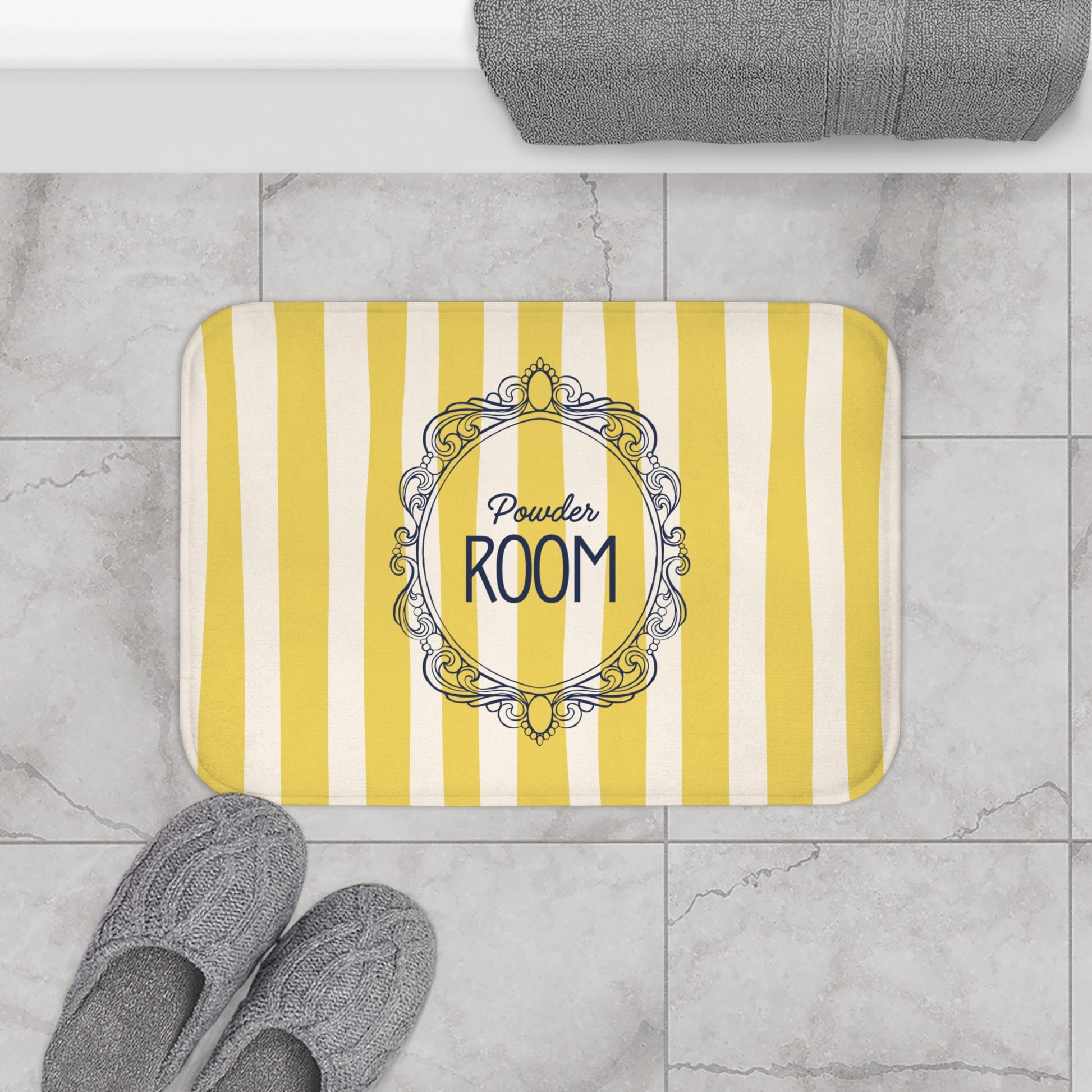 Yellow and white striped doormat with 'Powder Room' text on a tiled floor.