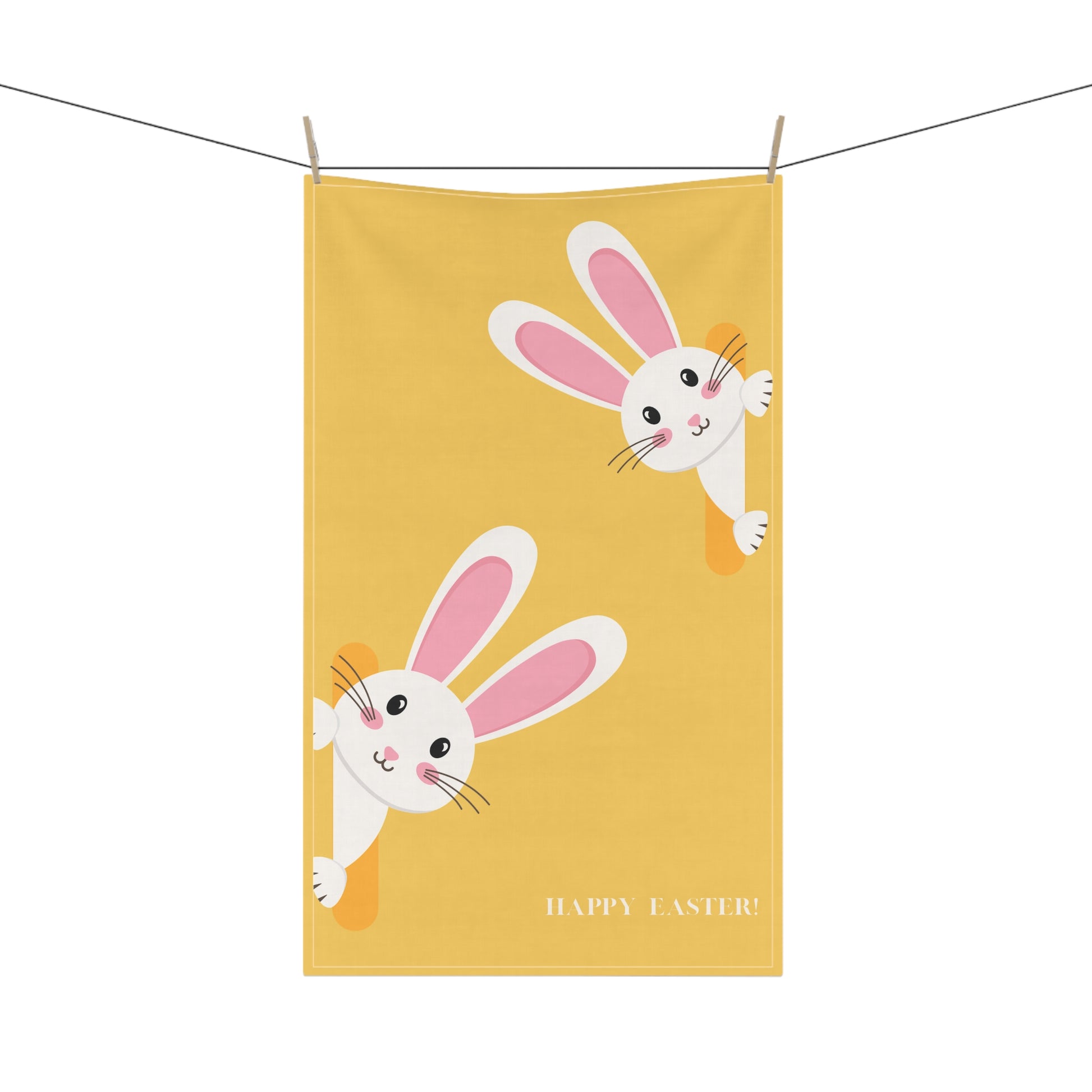 Yellow towel with cartoon bunnies and 'Happy Easter' text on a white background