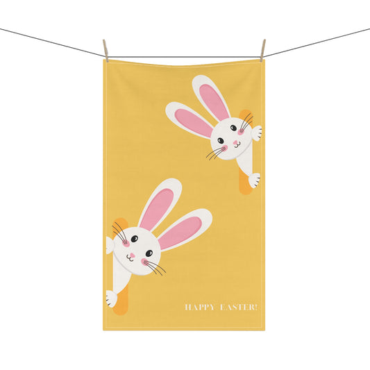 Yellow towel with cartoon bunnies and 'Happy Easter' text on a white background
