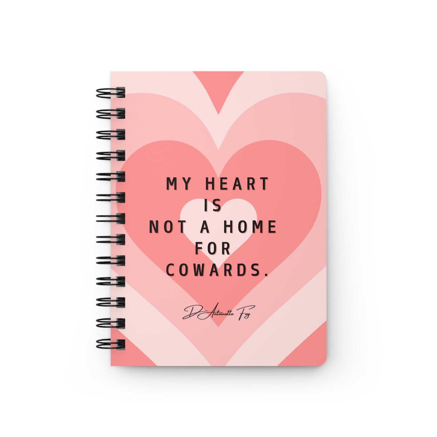 Notebook with heart design and text on a white background