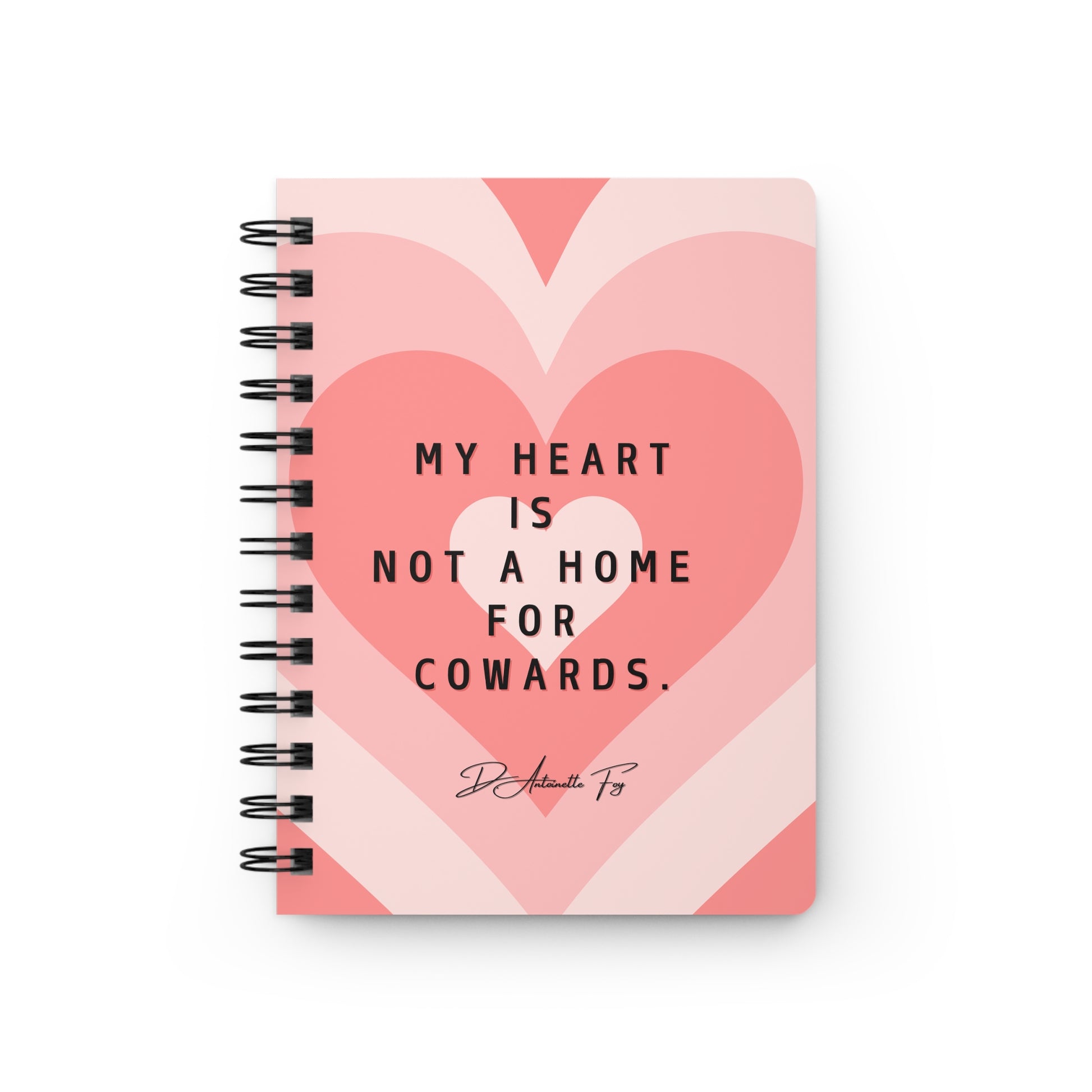 Notebook with heart design and text on a white background