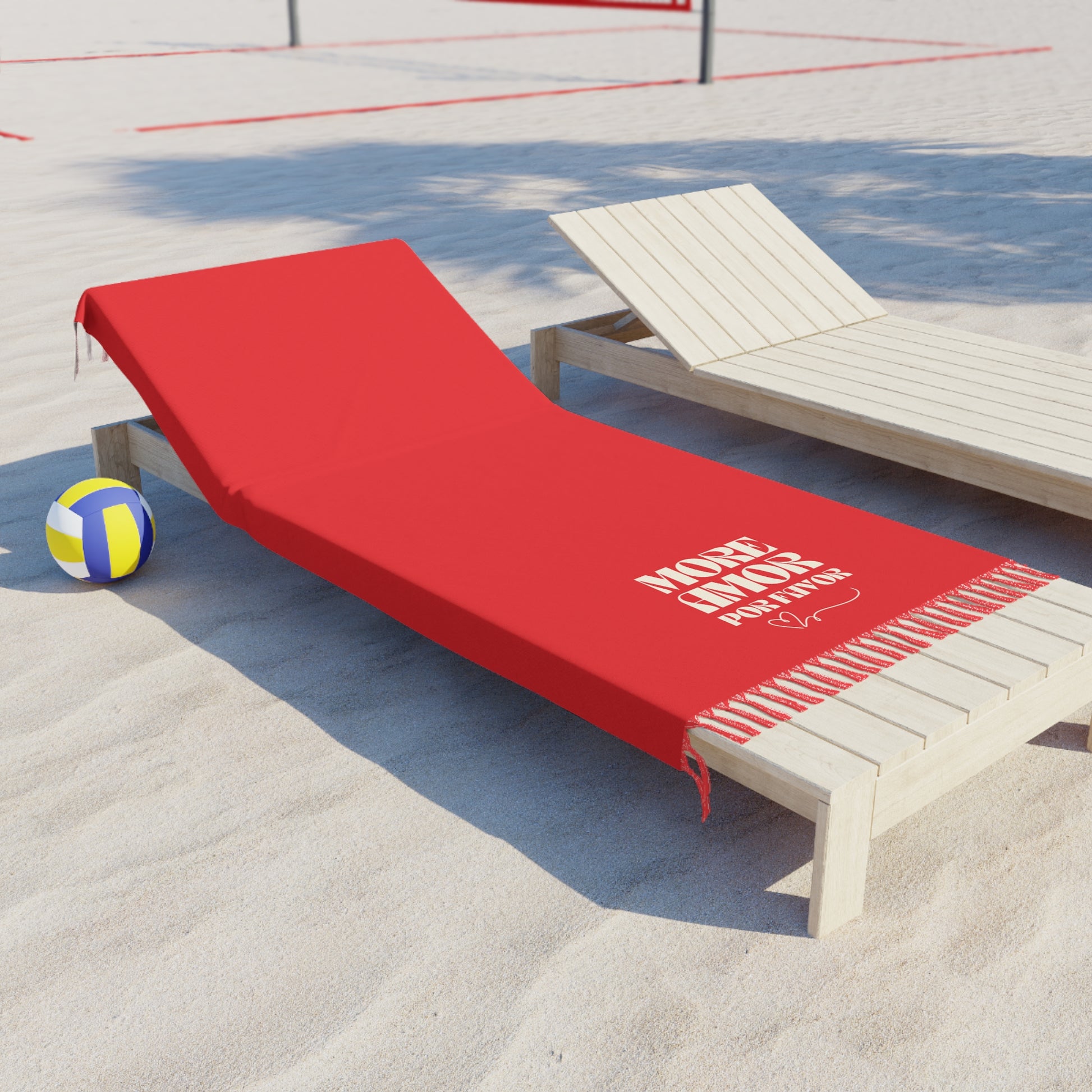 Red towel with text on a wooden lounge chair by a poolside.