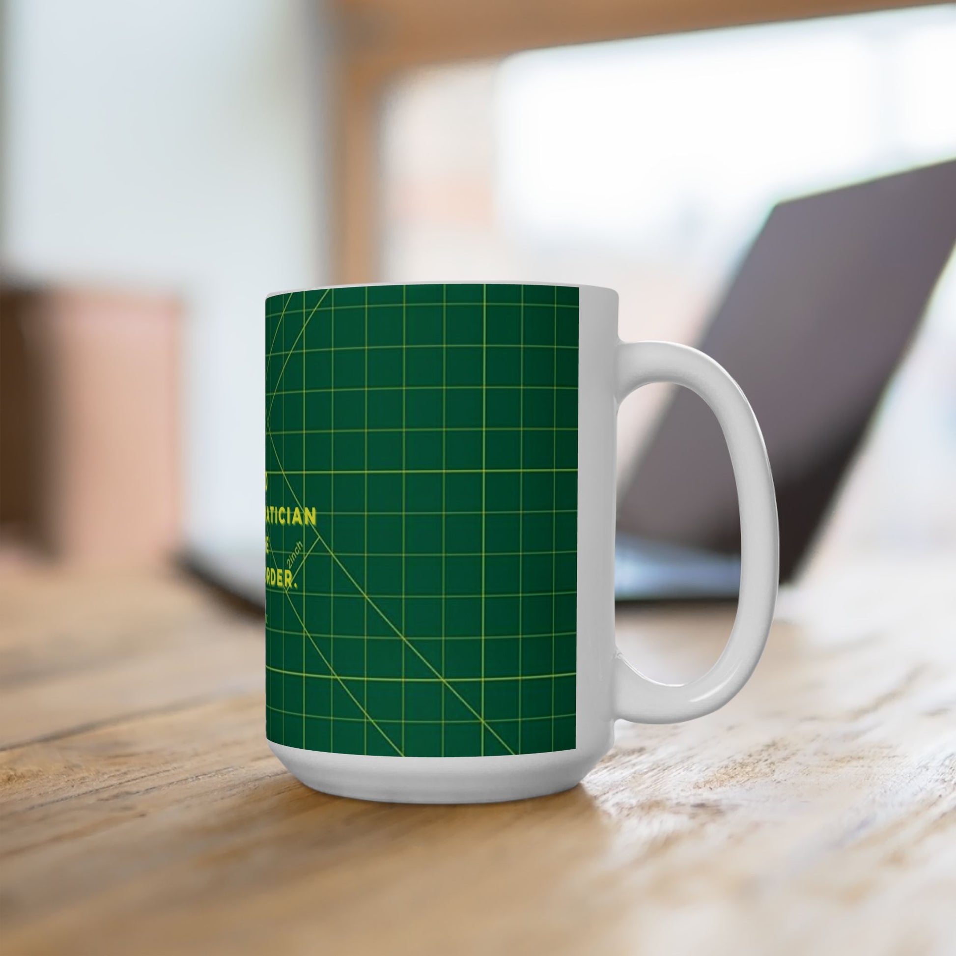 White mug with green grid pattern on a wooden surface