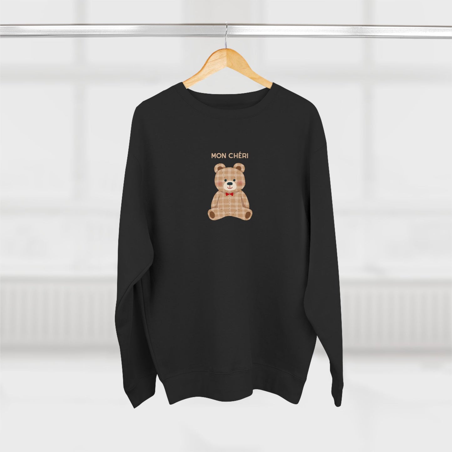 Black sweater with a teddy bear graphic and 'MON CHERI' text on a white background