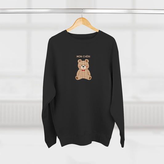 Black sweater with a teddy bear graphic and 'MON CHERI' text on a white background