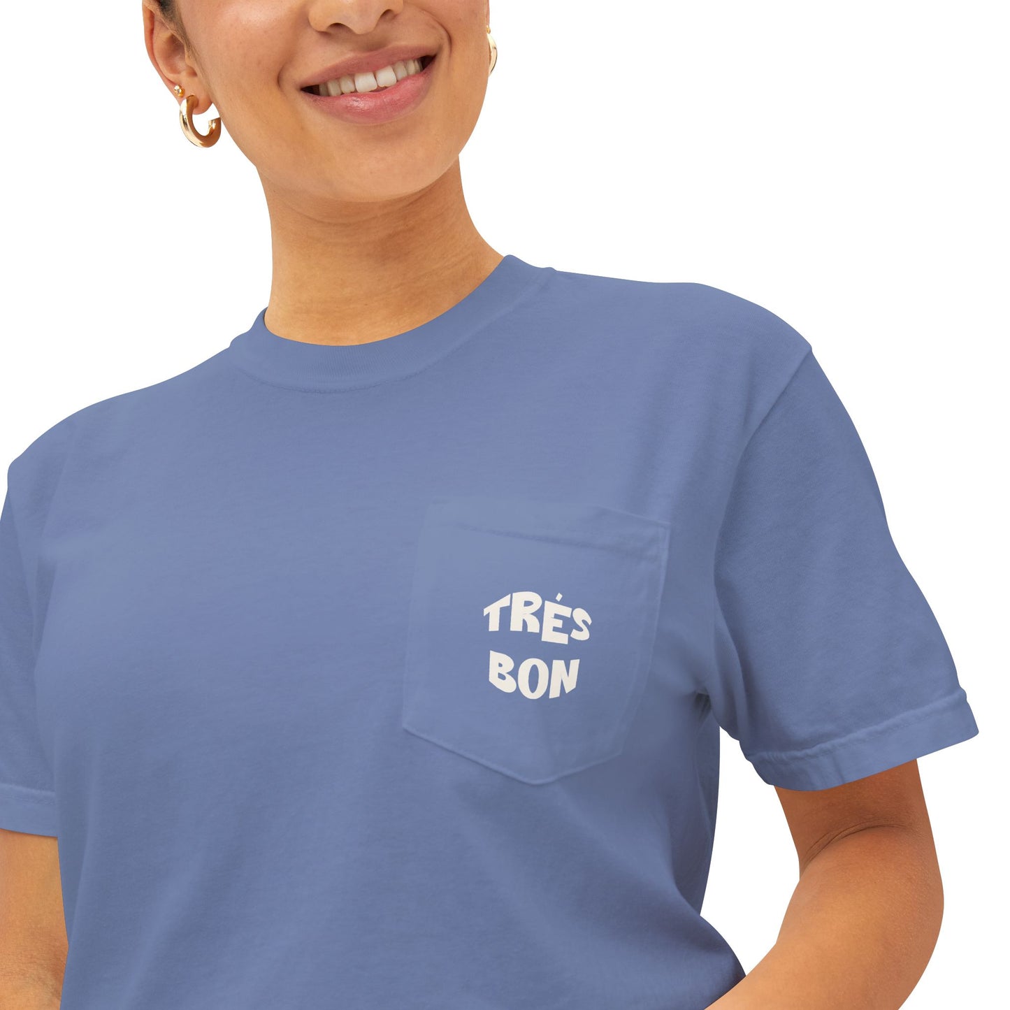 Person wearing a blue t-shirt with 'TRéS BON' text on a white background