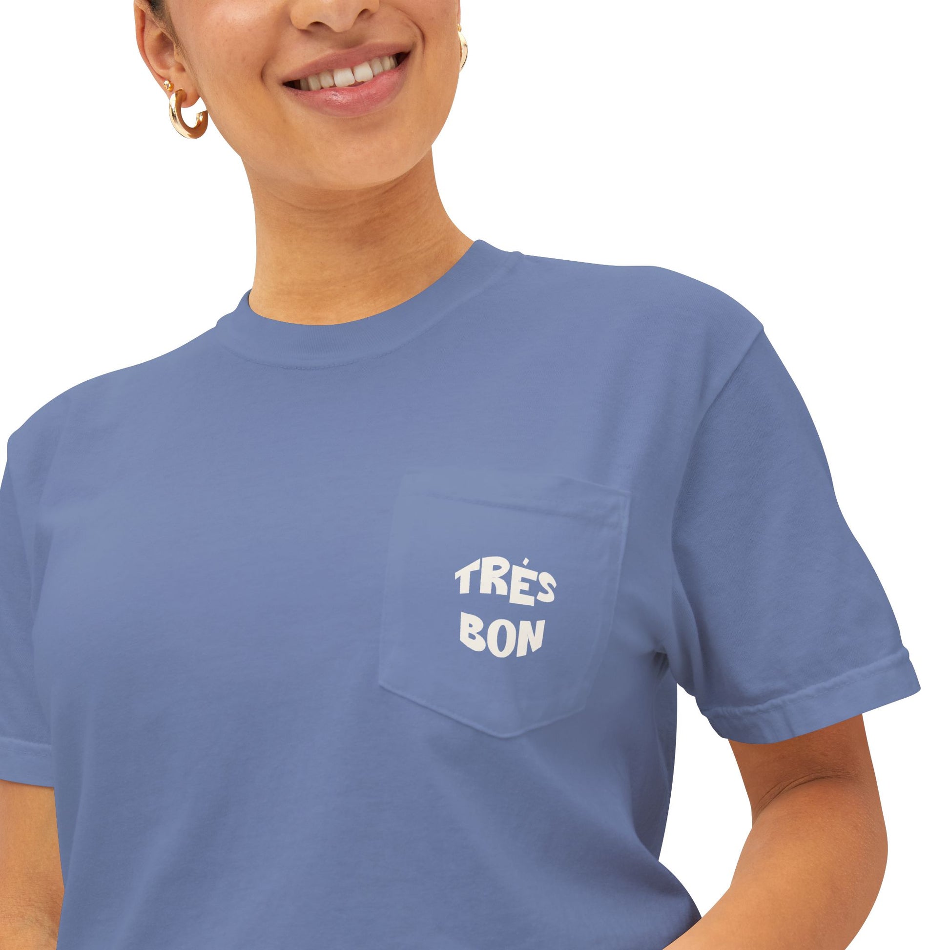 Person wearing a blue t-shirt with 'TRéS BON' text on a white background
