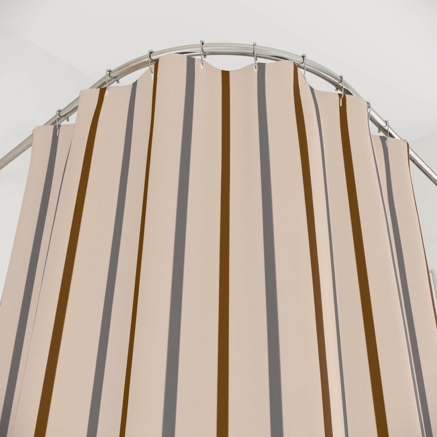 Beige and brown striped shower curtain on a metal rod against a white background