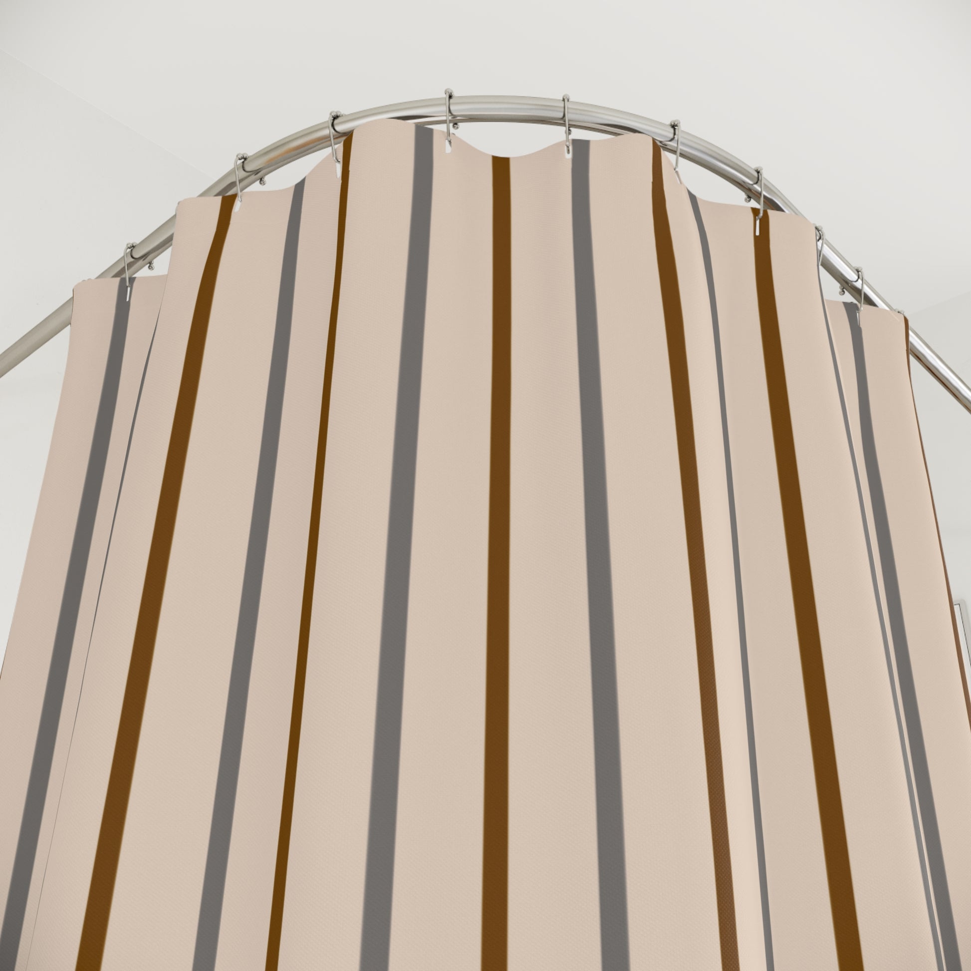 Beige and brown striped shower curtain on a metal rod against a white background