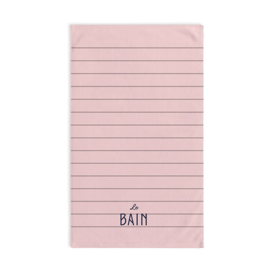 Pink towel with horizontal stripes and 'Le Bain' text on a white background