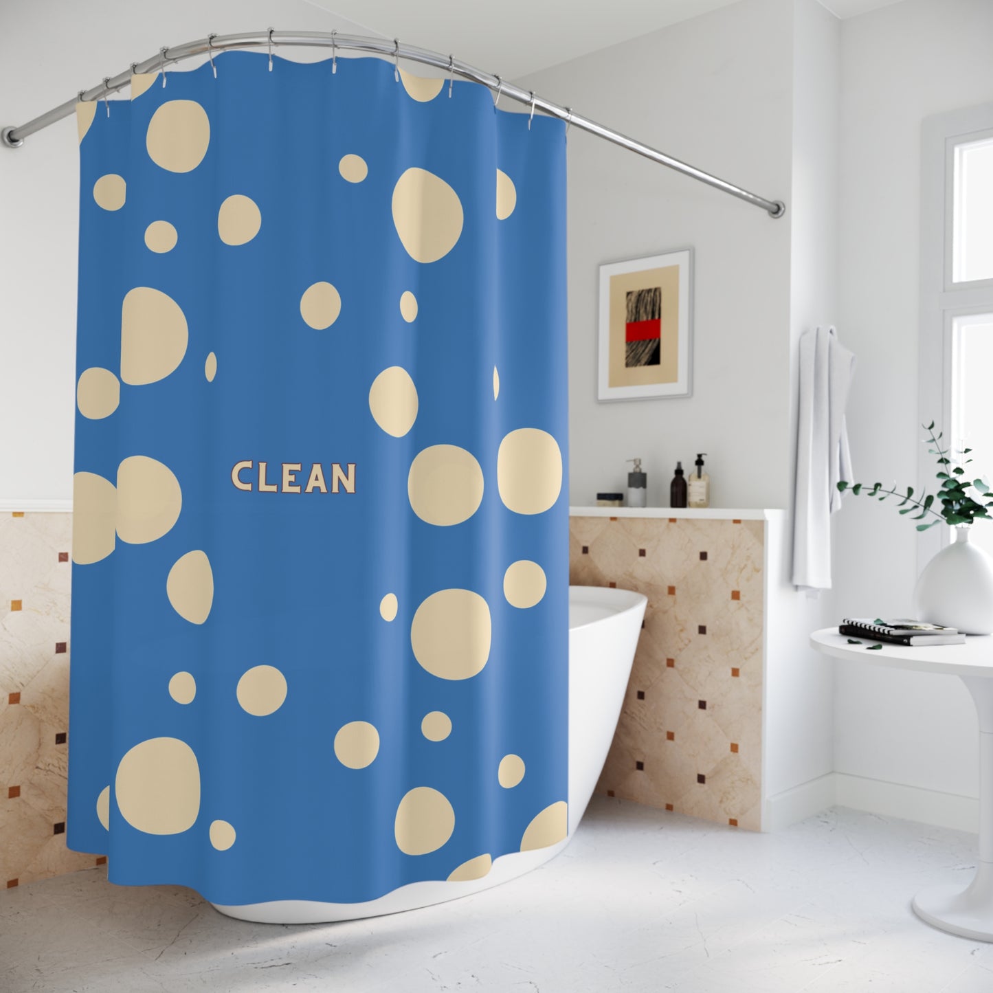 A blue shower curtain with beige polka dots and the word 'CLEAN' printed in beige, hanging in a bright white bathroom next to a bathtub.