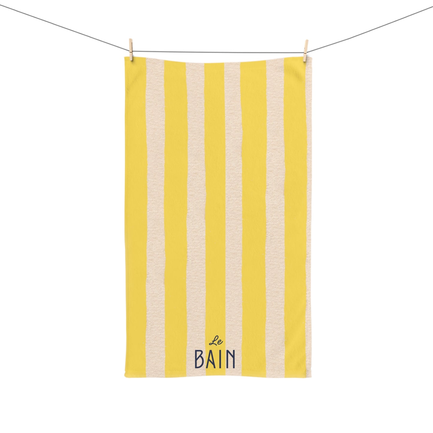 Yellow and beige striped towel with 'Le Bain' text on a white background