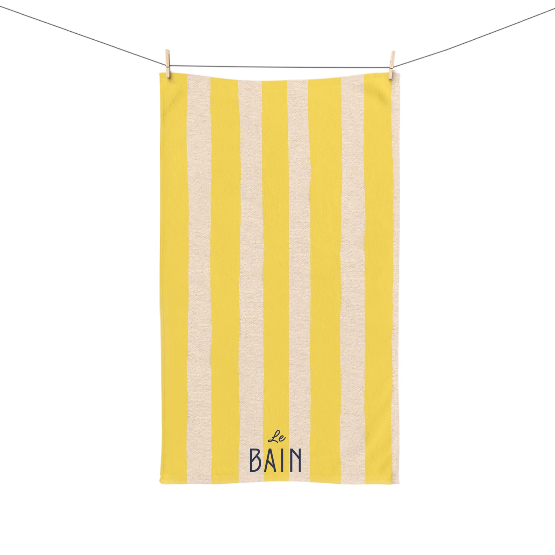 Yellow and beige striped towel with 'Le Bain' text on a white background