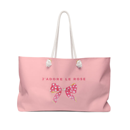 Pink tote bag with a bow and 'J'adore Le Rose' text on a white background