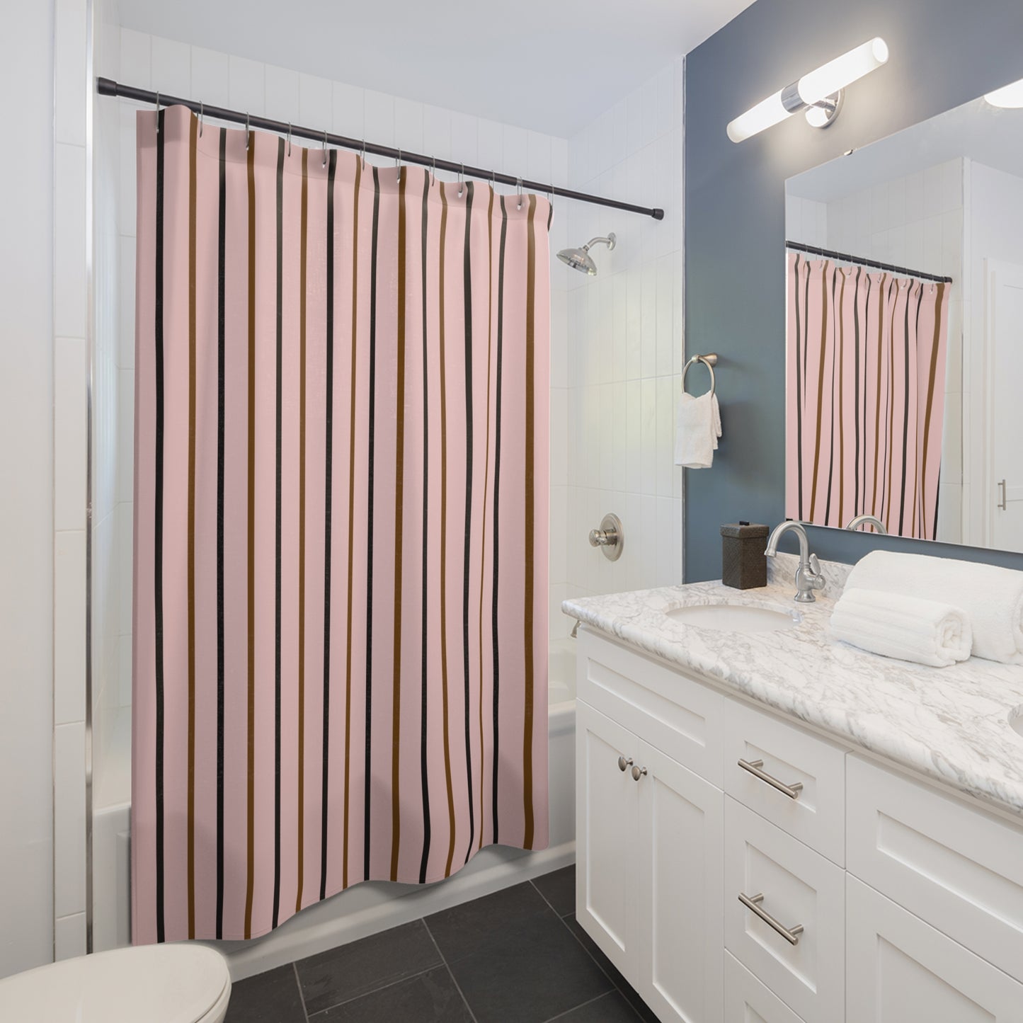 Bathroom with striped shower curtain, white vanity, and mirror.