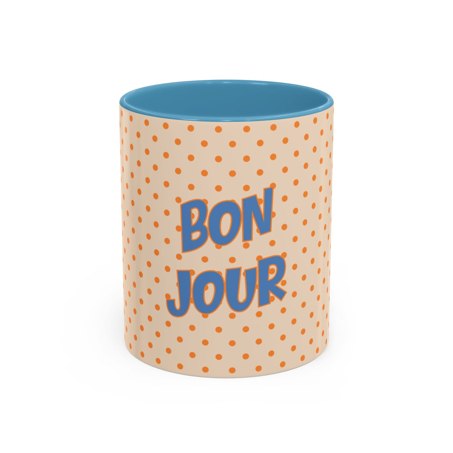 Mug with polka dot pattern and 'Bonjour' text on a white background