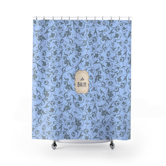 Shower curtain with blue floral pattern and 'Le Bain' label on a white background