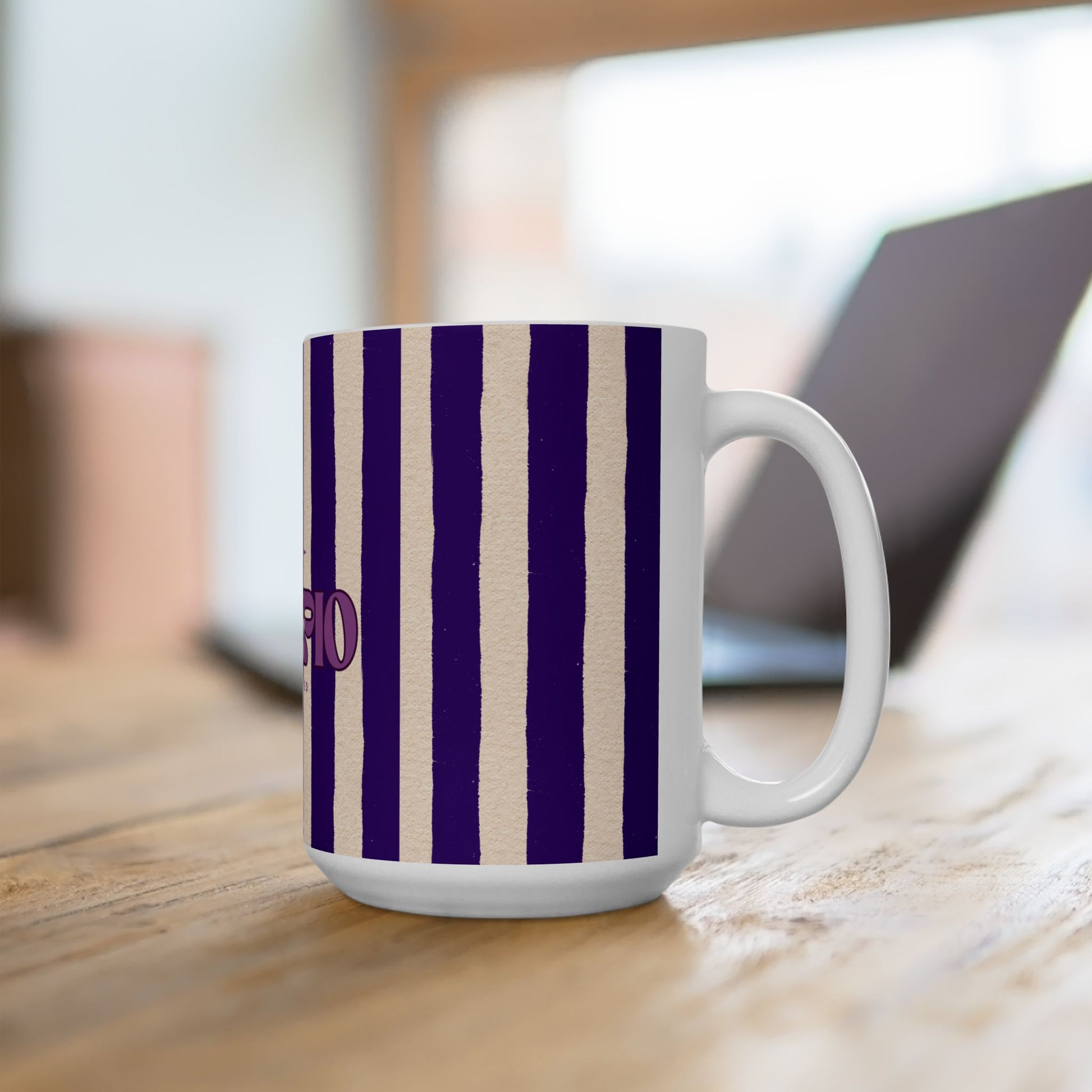 White mug with purple and beige striped pattern on a wooden surface