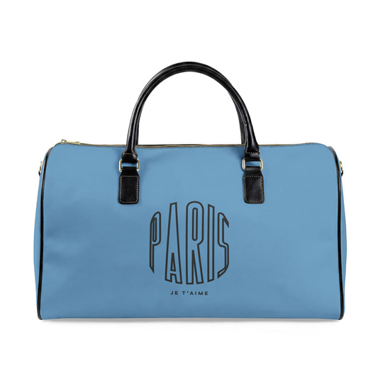 Blue duffel bag with 'Paris Je T'aime' text on a white background