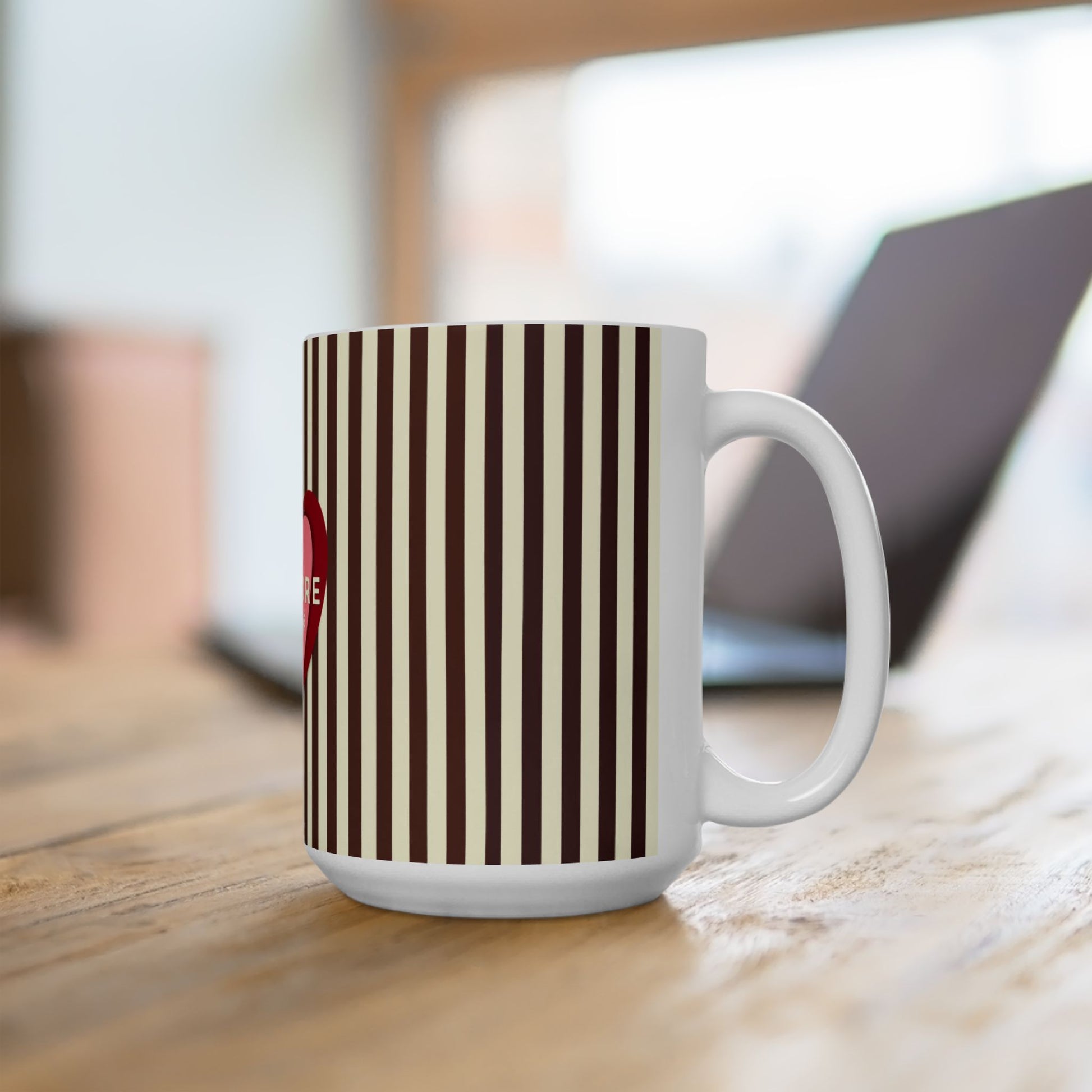 White mug with brown and beige striped pattern on a wooden surface