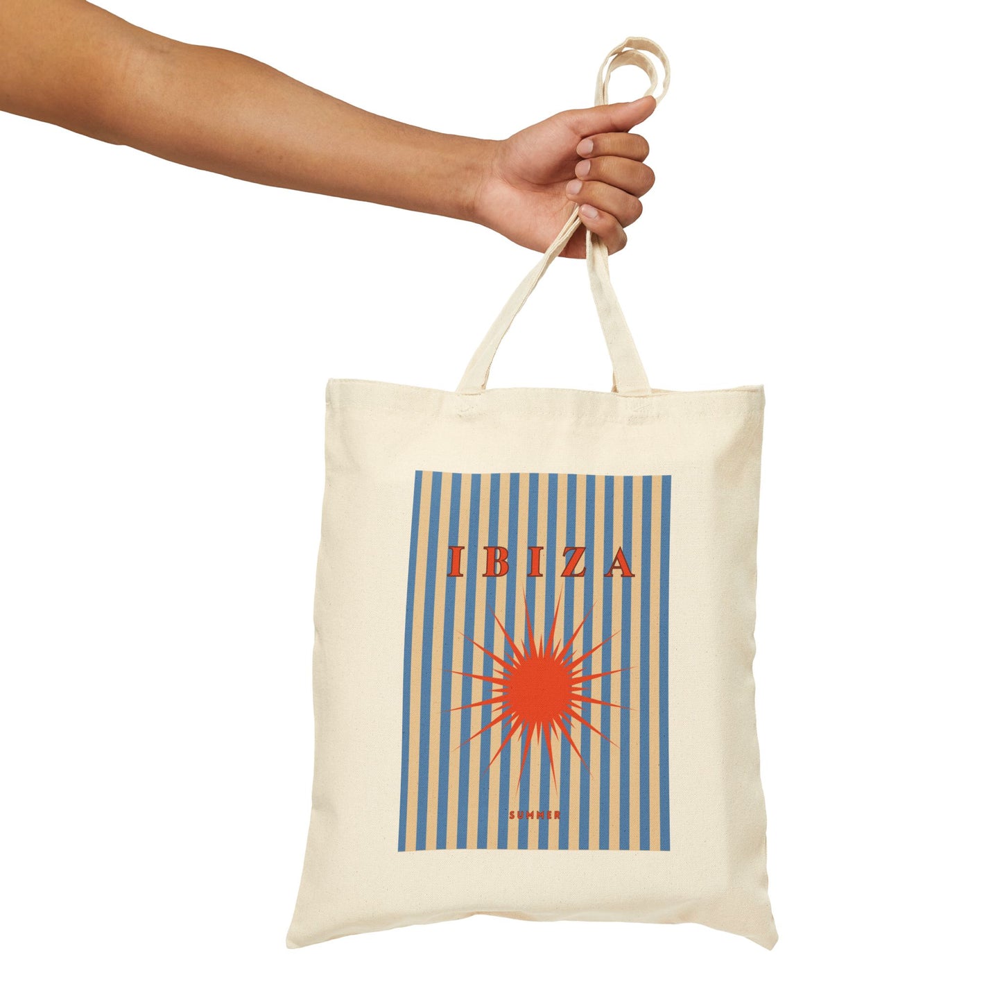 Tote bag with 'IBIZA' design held by a hand on a white background