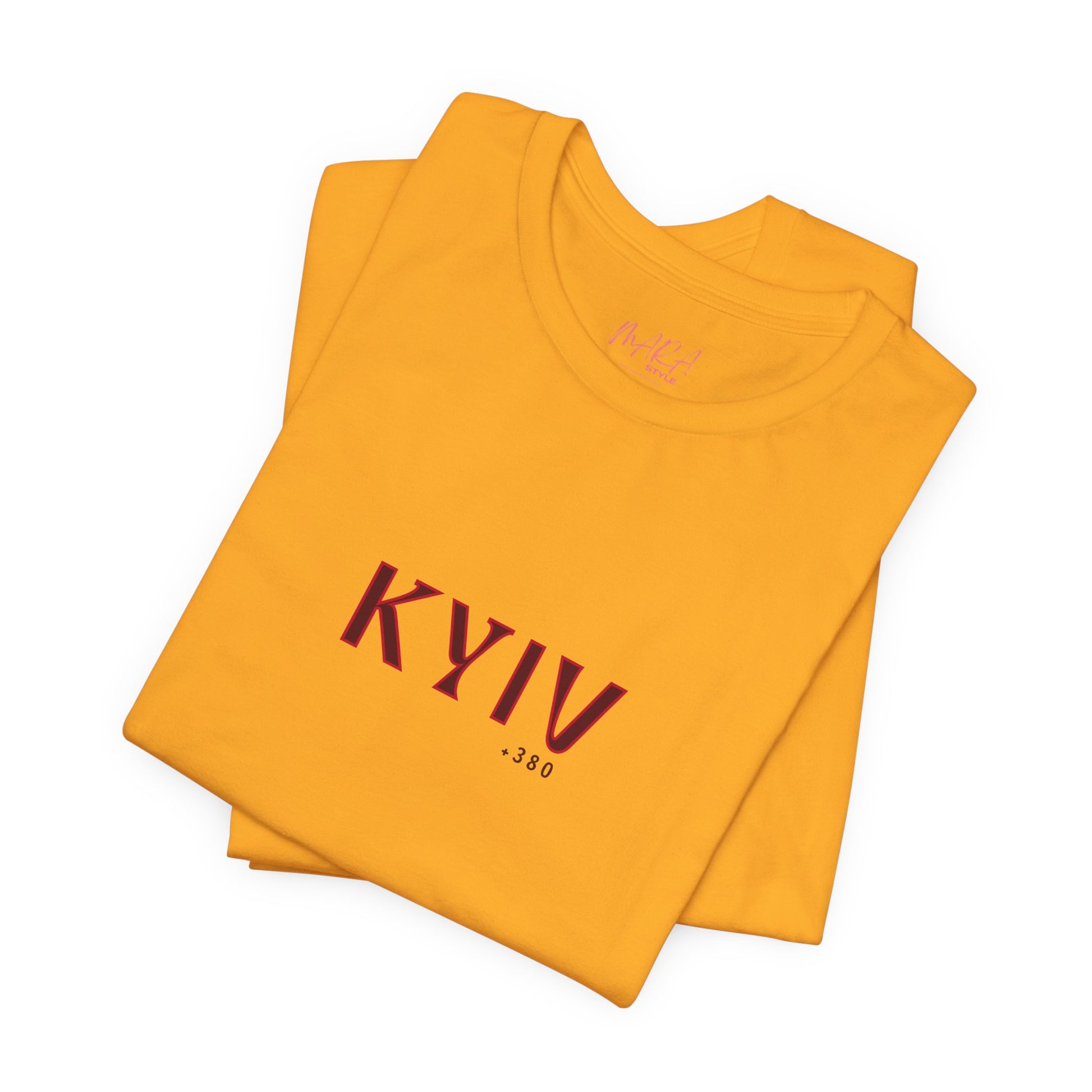 Folded yellow t-shirt with 'KYIV 380' text on a white background