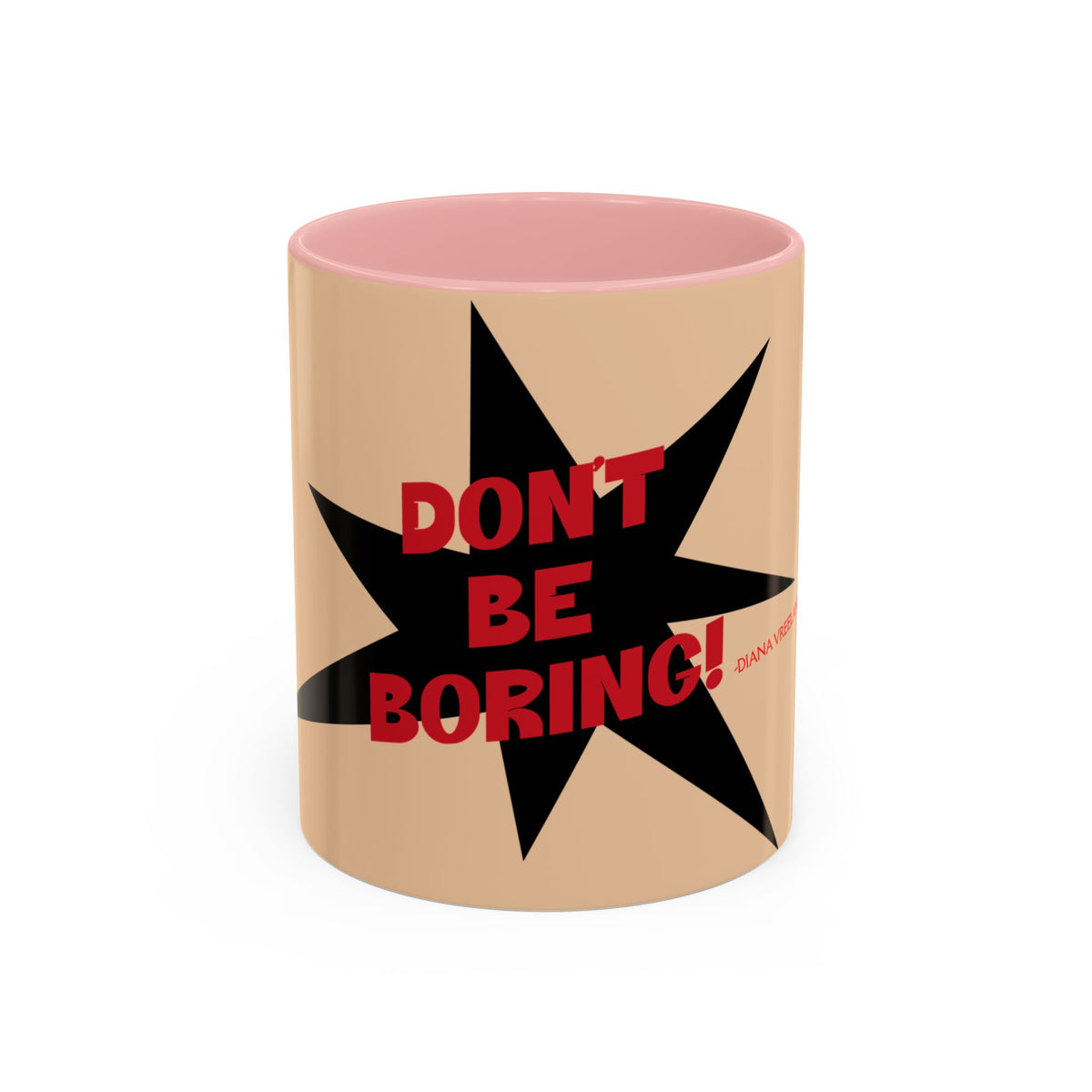 A ceramic mug with a beige exterior, a pink interior, and a black starburst graphic featuring the red text 'DON'T BE BORING!' on the front.
