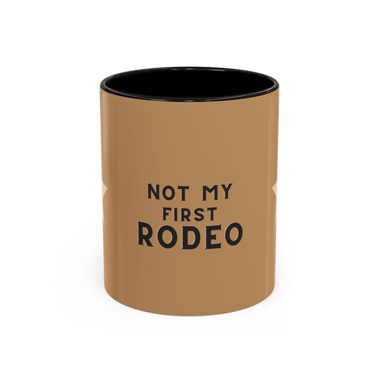 Brown mug with black interior and 'Not My First Rodeo' text on a white background