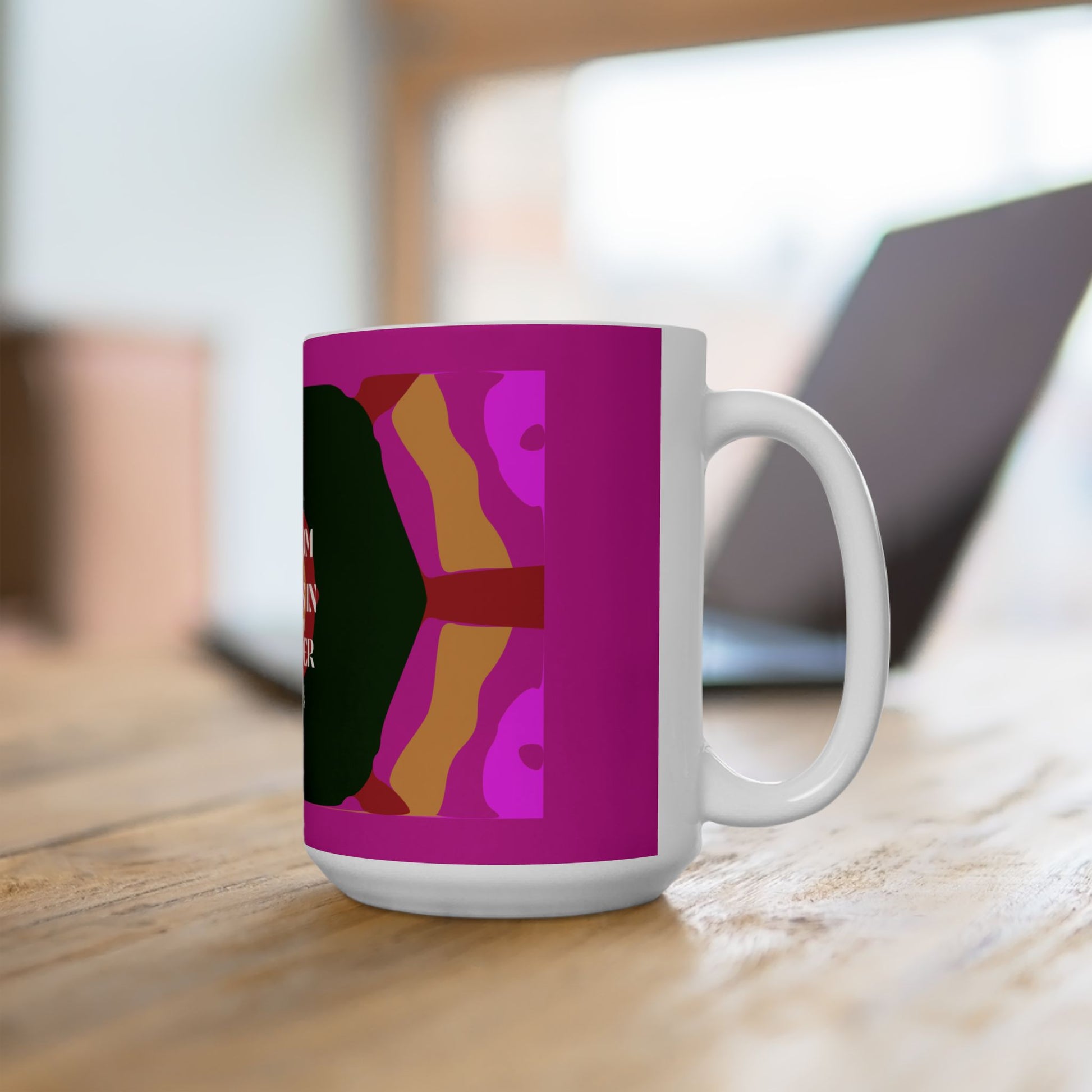 White mug with colorful design on a wooden surface