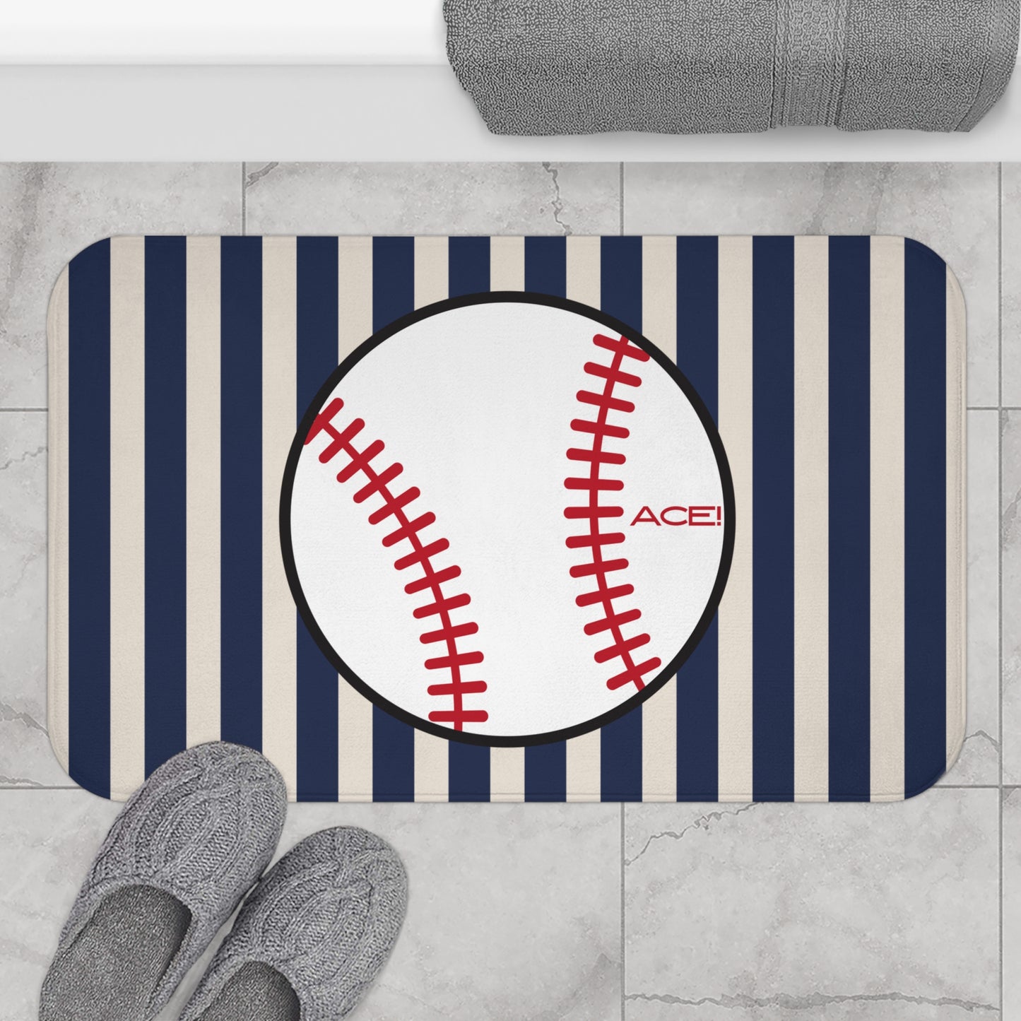 Baseball-themed bath mat with striped pattern on a bathroom floor.