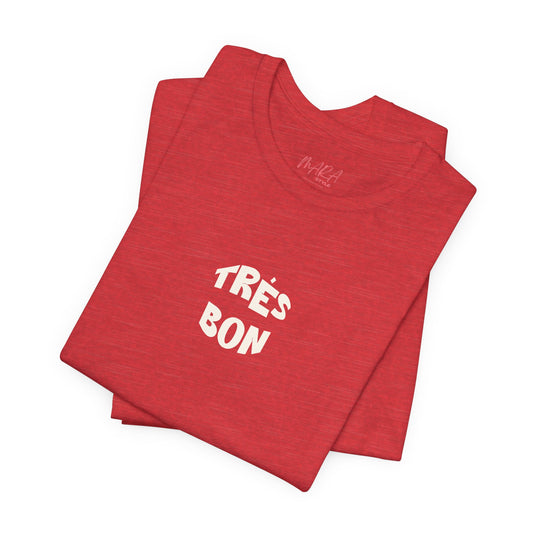 Folded red t-shirt with 'TRèS BON' text on a white background