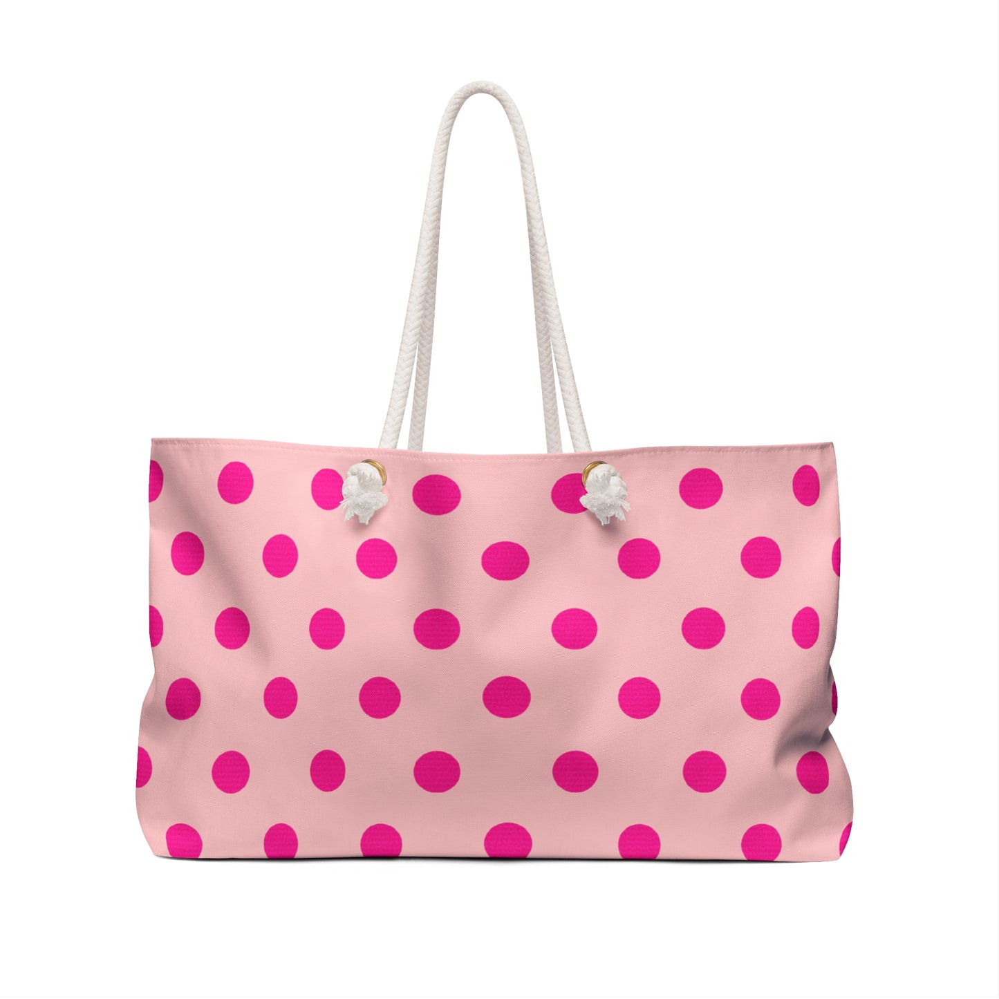 Pink tote bag with white polka dots on a white background