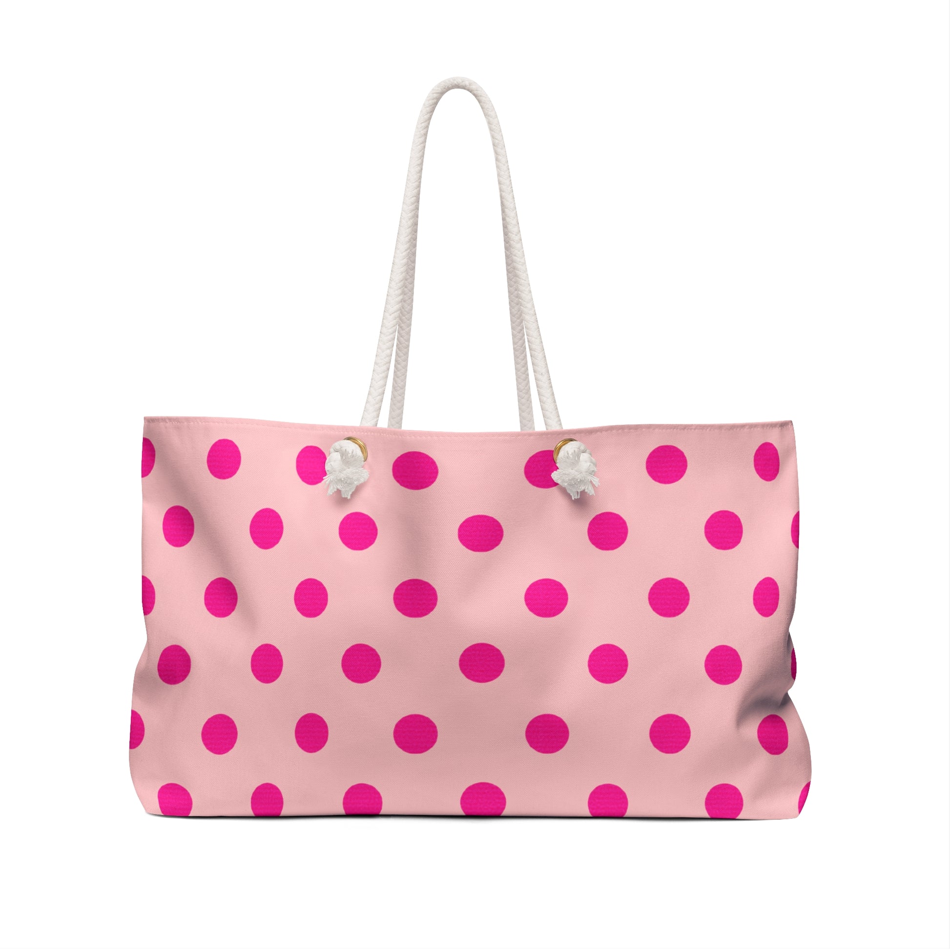Pink tote bag with white polka dots on a white background