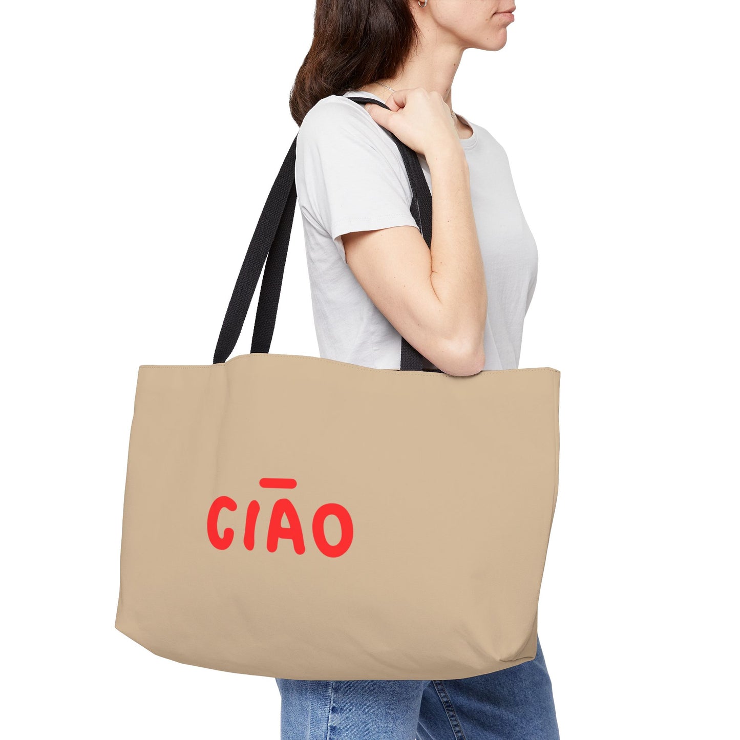 Person holding a beige tote bag with 'CIAO' in red text on a white background
