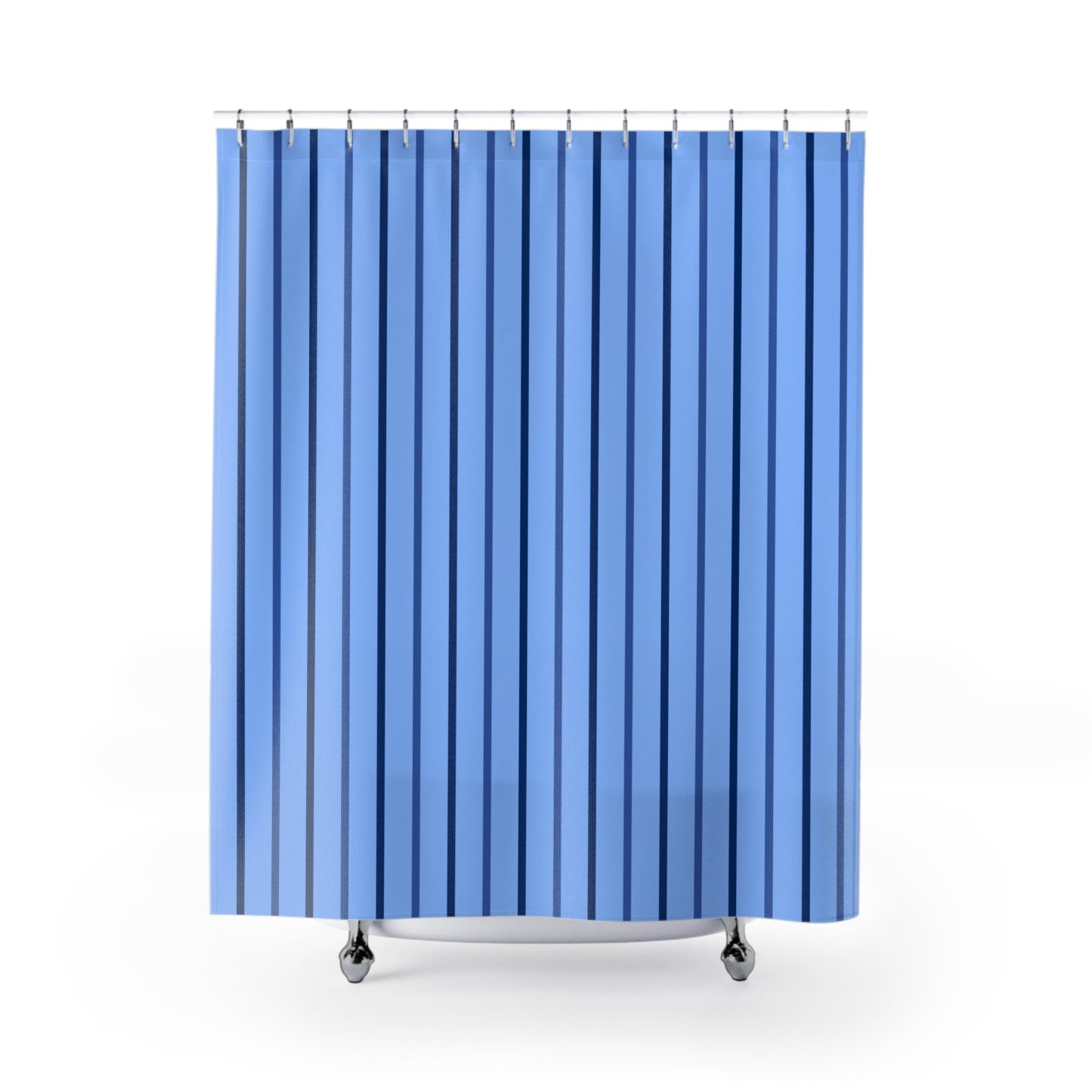 A blue shower curtain with vertical stripes in varying shades of blue, hanging from silver rings on a white background.