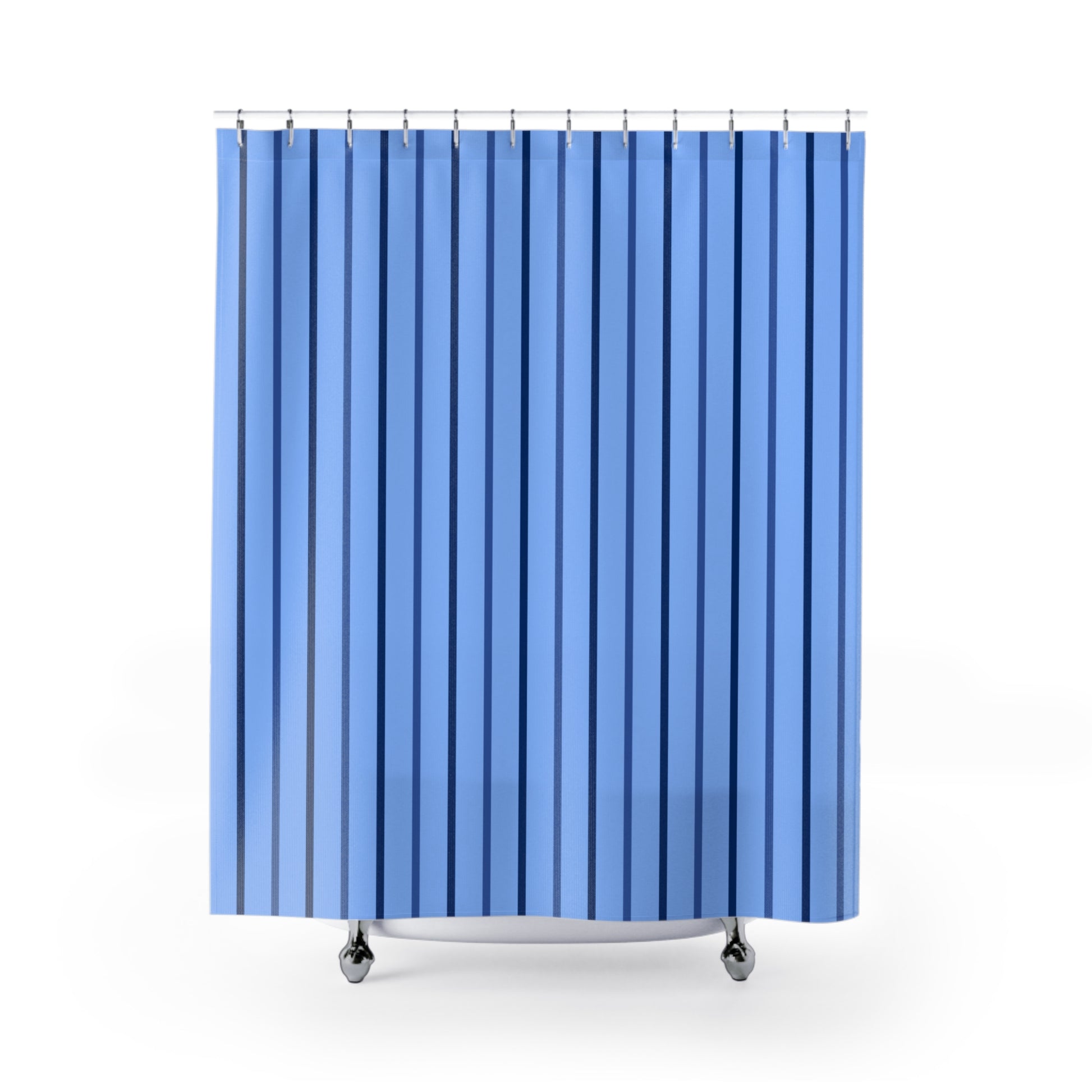 A blue shower curtain with vertical stripes in varying shades of blue, hanging from silver rings on a white background.