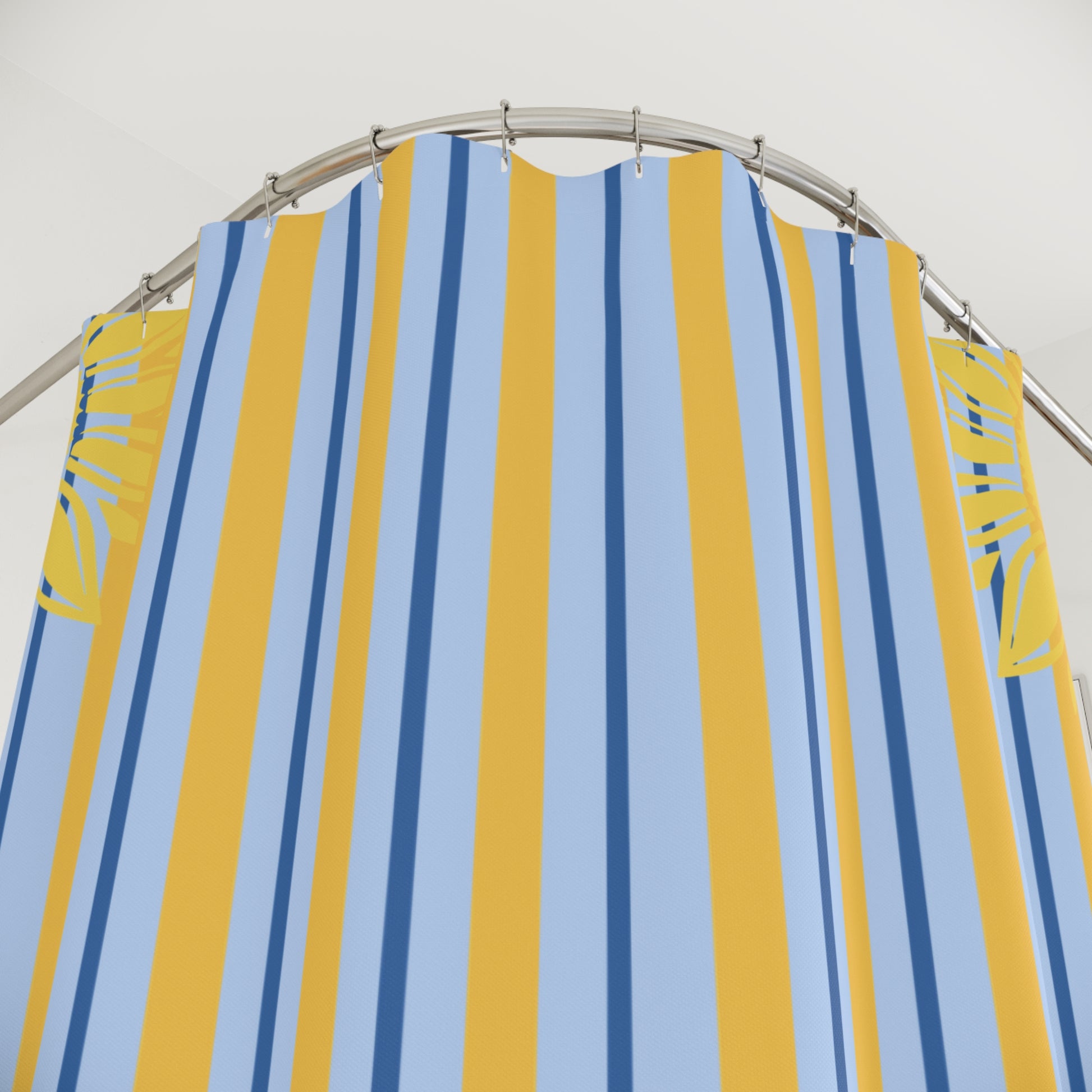 A striped beach tent or lounge cover with vertical yellow, light blue, and navy stripes, hanging from a curved metal frame against a white background.