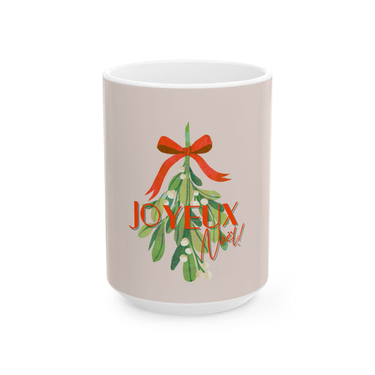 Mug with Christmas design featuring a red bow and green leaves with 'JOYEUX NOEL' text on a beige background.