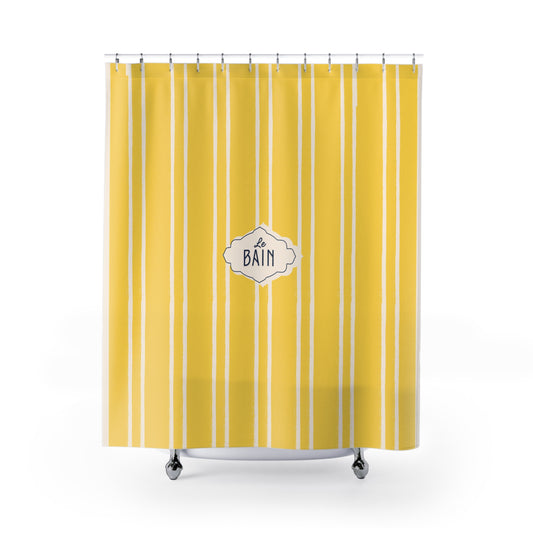Yellow striped shower curtain with 'Le Bain' label on a white background