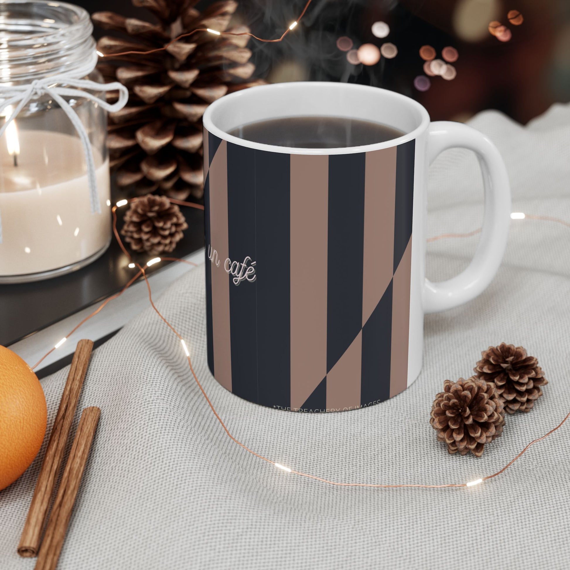 Mug with striped design on a table with decorative items