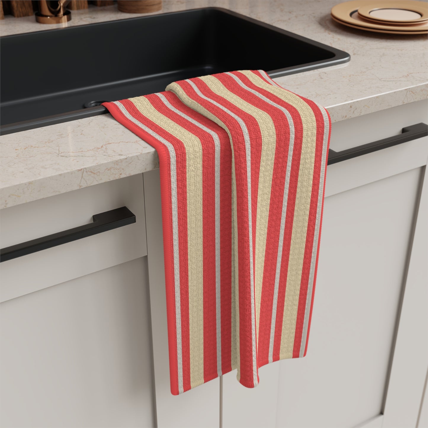 Red and beige striped towel hanging on a kitchen cabinet handle.