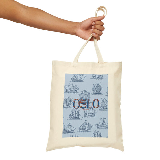 Tote bag with 'Oslo' design held by a hand on a white background