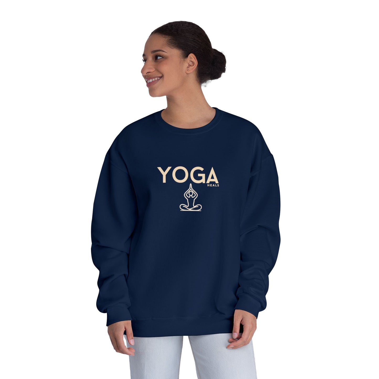 Person wearing a navy blue sweatshirt with YOGA Heals text