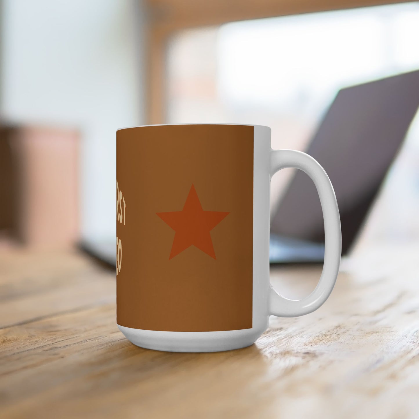 Brown mug with a red star on a wooden surface