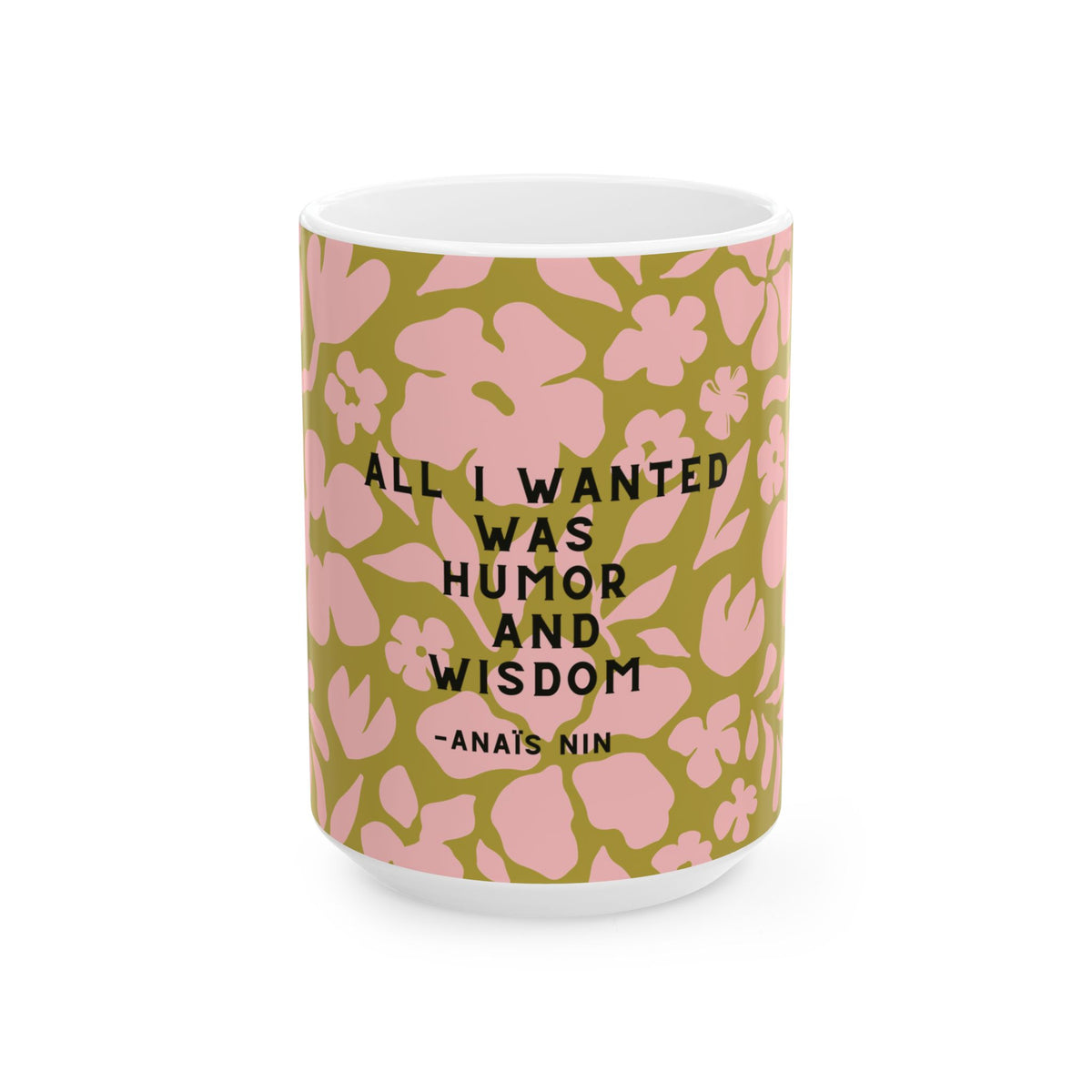 A white ceramic mug with a green and pink floral pattern, featuring the quote 'ALL I WANTED WAS HUMOR AND WISDOM -ANA'S NIN' in black text.