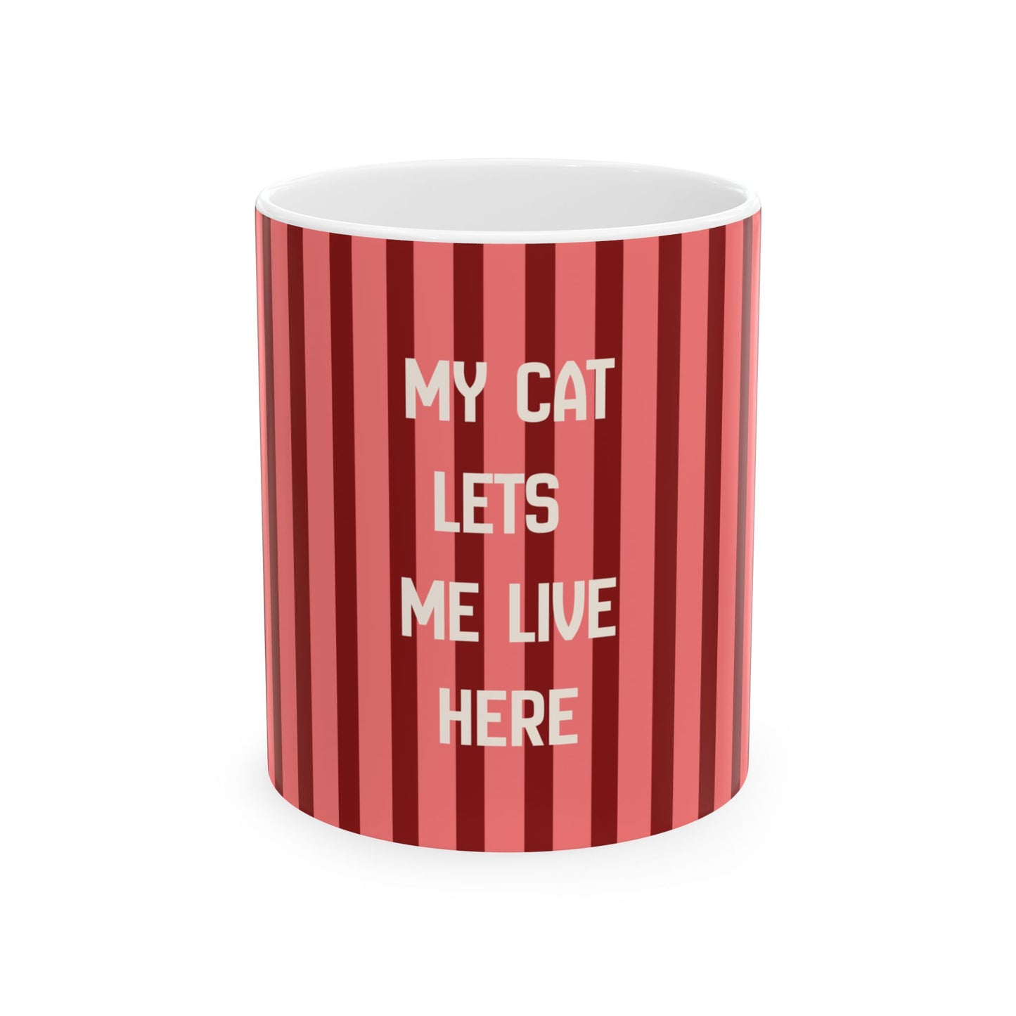 A white ceramic mug with a red and pink vertical striped pattern, featuring the text 'MY CAT LETS ME LIVE HERE' in white capital letters, shown on a plain white background.
